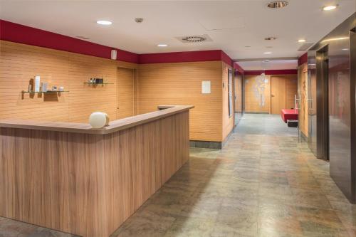 a lobby of a hospital with a reception counter at Eurostars Rey Fernando in Zaragoza