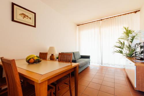 a living room with a table and a couch at Residence Renaione in Punta Ala
