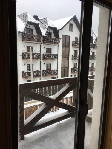 a view from a window of a building with snow at VULYK z MEDOM in Bukovel