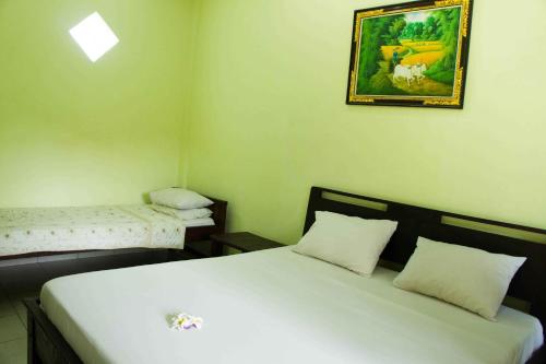 Jungut Inn tesisinde bir odada yatak veya yataklar