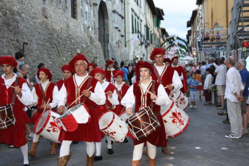 a group of people walking down a street with drums at Locanda San Barnaba in Scarperia