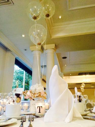 a table with chandeliers and a table with a table sidx sidx at Winchester Wessex Hotel by Sunday in Winchester