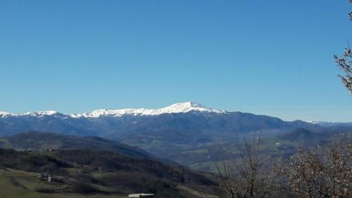 a snow covered mountain in the distance at Albergo Sapori in Tolè