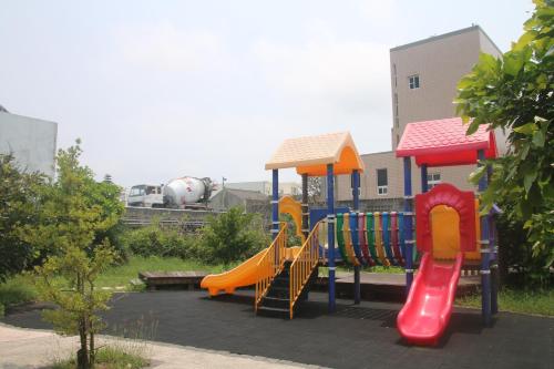 a playground with a slide in a park at 逸遊蔚境民宿 in Magong