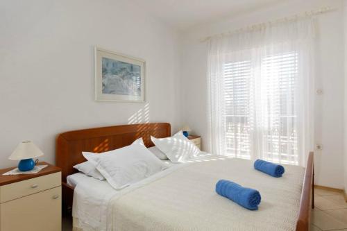 Postel nebo postele na pokoji v ubytování Apartments Bogdanić