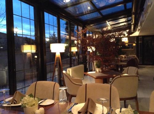 a restaurant with tables and chairs and a large window at Warwick Ankara in Ankara