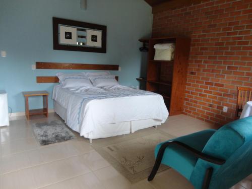 Ένα ή περισσότερα κρεβάτια σε δωμάτιο στο Pousada Ponta da Pedra