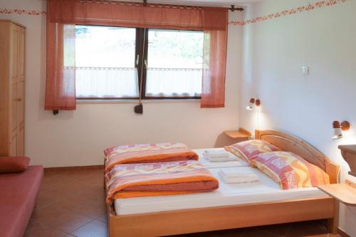 a small bedroom with a bed with a window at Apartments Bobi in Tolmin