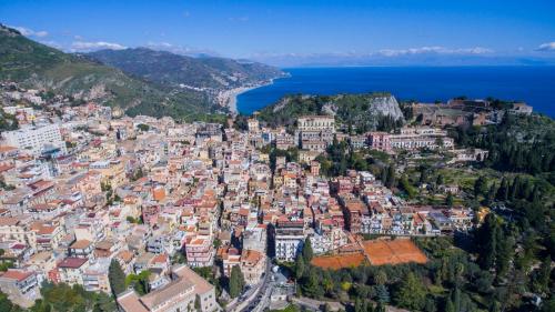 an aerial view of a city with the ocean at Hotel Villa Paradiso in Taormina