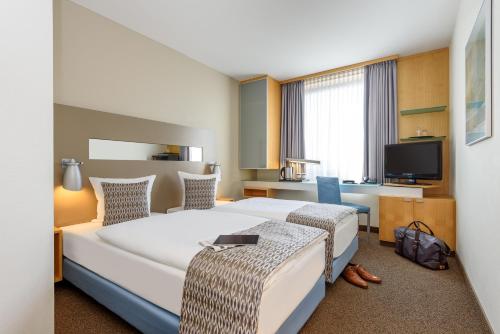 Säng eller sängar i ett rum på Mercure Hotel Düsseldorf City Nord
