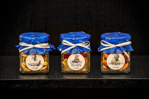 four small bottles of honey with blue bows on them at Artagonist Art Hotel in Vilnius