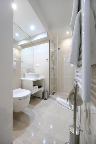 a white bathroom with a toilet and a shower at Lipotica Luxury Accommodation in Zadar