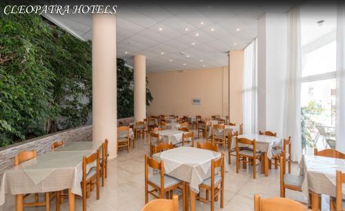 a restaurant with tables and chairs and a large window at Kris Mari in Kardamaina