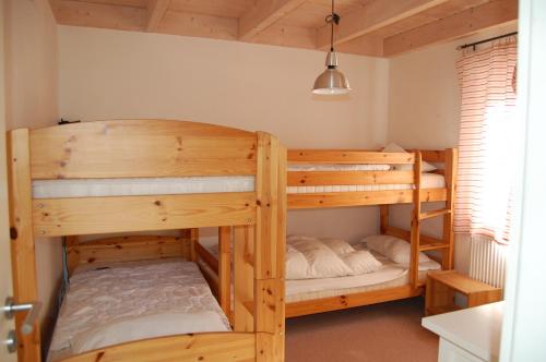 a bedroom with two bunk beds in a room at Traumhäuser am See in Rieden