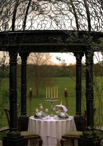 a table with candles on it under a gazebo at Goldsborough Hall in Knaresborough