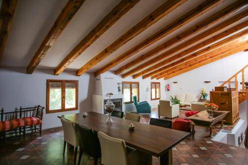 a living room with a wooden table and chairs at Molino del Machero in Puebla de Don Fadrique