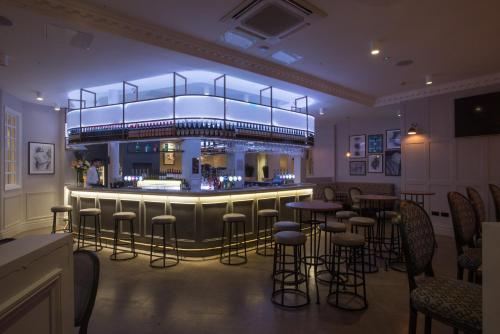 a bar in a restaurant with bar stools at The Kings Head Hotel in London