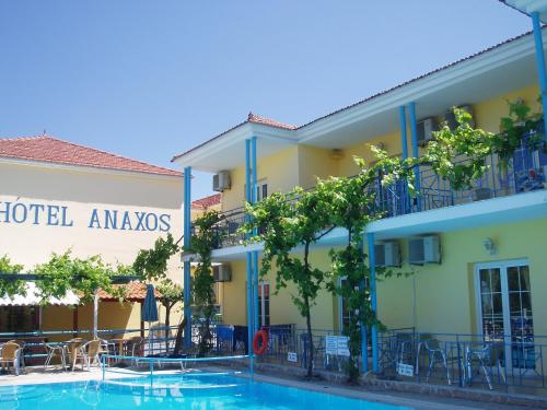 a hotel with a swimming pool in front of a building at Anaxos Hotel in Anaxos