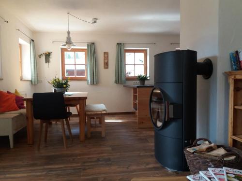 a kitchen and dining room with a refrigerator and a table at Das Prinzis in Lofer