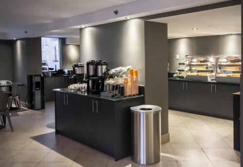 a restaurant with a counter with a buffet of food at Hotel Faubourg Montreal Centre-Ville Downtown in Montréal