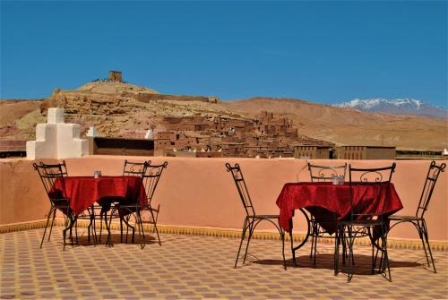 a group of chairs and tables on a roof at La Baraka Auberge in Aït Ben Haddou