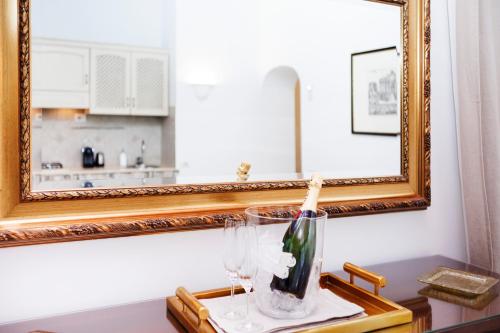 a vase on a table in front of a mirror at Tritone 91 Apartments in Rome