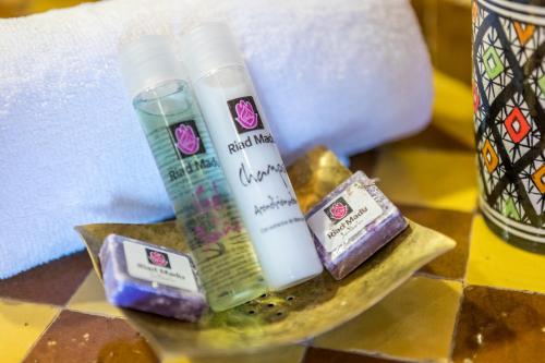 a table with two bottles of moisturizers and soap at Riad Madu in Merzouga