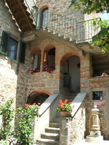 a stone building with a staircase and a balcony at Villa Schiatti in Cortona