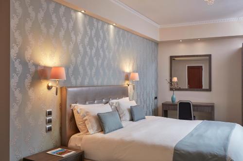 Postel nebo postele na pokoji v ubytování Ava Hotel and Suites