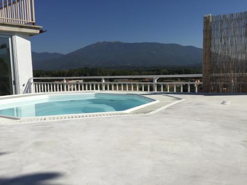 a swimming pool on the roof of a house at Les Suites in Santa María de Palautordera