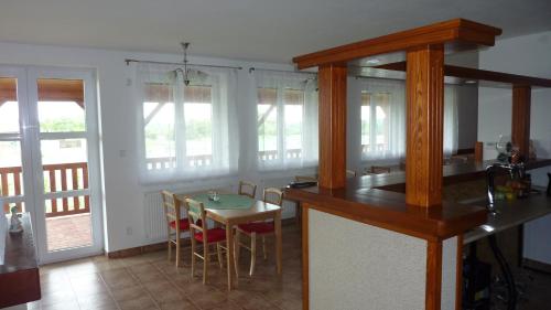 a kitchen with a counter and a table with chairs at Penzion Slávka in Třemošnice