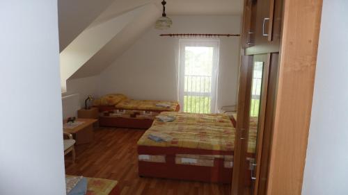 a bedroom with a bed and a window at Penzion Slávka in Třemošnice