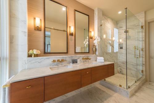 a bathroom with a sink and a shower at The Dewberry Charleston in Charleston