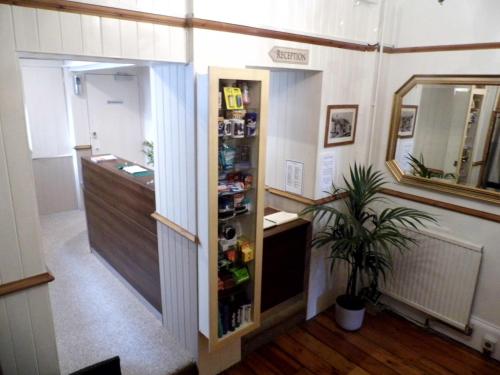 a hallway with a refrigerator in a room at Waterfront Hotel in Deal