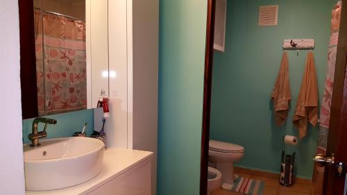 a bathroom with a sink and a toilet at Fully Air-Conditioned Beach Front Penthouse Apartment in Naguabo