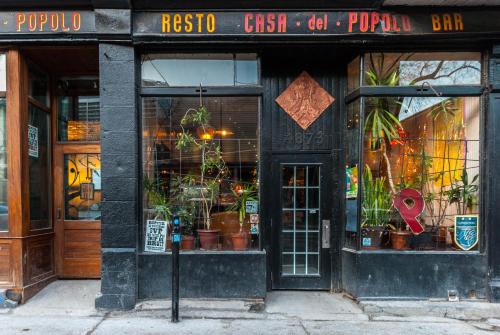 a store with potted plants in the front of a building at Pensione Popolo in Montréal