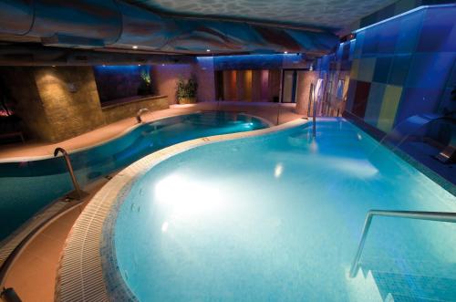 a large swimming pool in a building at Spa Hotel Ciudad de Teruel in Teruel