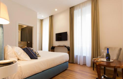 Un pat sau paturi într-o cameră la 900 Piazza del Popolo