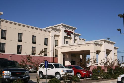 a white building with cars parked in front of it at Hampton Inn Greenwood in Greenwood