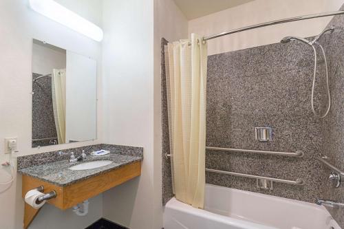 a bathroom with a sink and a shower at Budget Inn Ganado in Ganado