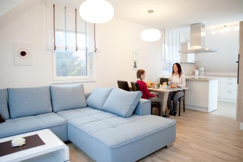 two women sitting at a table in a living room at Haus Rosy Ferienwohnung in Stubenberg
