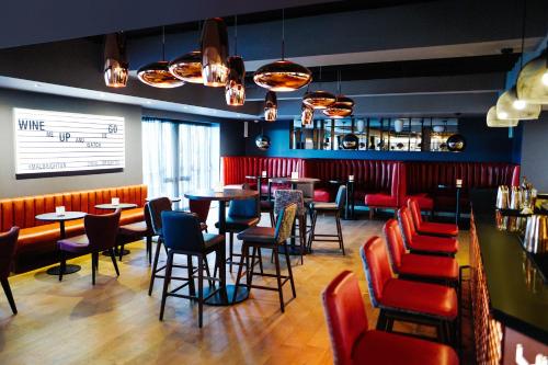 a restaurant with tables, chairs, and tables in it at Malmaison Brighton in Brighton & Hove