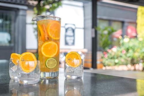 three glasses of orange juice sitting on a table at Mick O'Sheas in Hackham