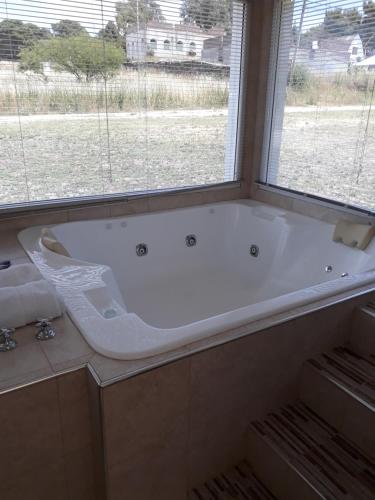 a bath tub in a bathroom with a window at Complejo Sol&Luna in Villa Ventana