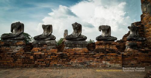 a brick wall with statues of cats on it at Banchan Hostel in Phra Nakhon Si Ayutthaya