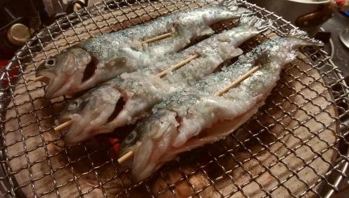 a bunch of fish in a basket with chopsticks at Twin Dome Ryugu in Hokuto