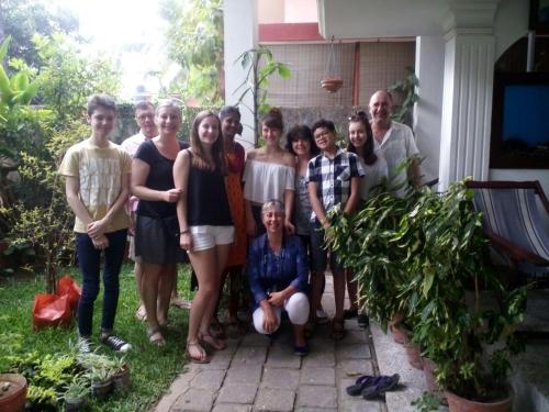 a group of people posing for a picture in front of a house at Nathans Holiday Home in Cochin