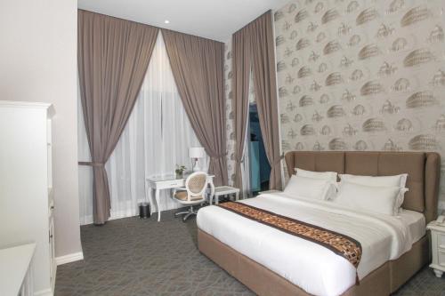 a bedroom with a bed and a desk in a room at Casa Bianca in Kluang
