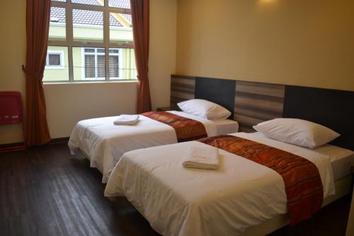 Un ou plusieurs lits dans un hébergement de l'établissement Hotel Intan Jugra
