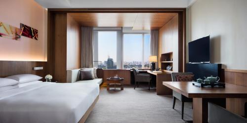 a hotel room with a bed and a desk at Hyatt Regency Changchun in Changchun